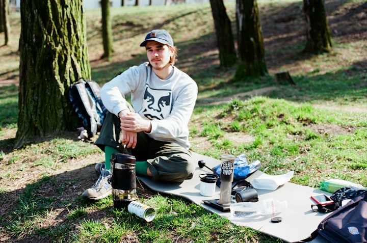 A man on a picnic during camping with his gear
