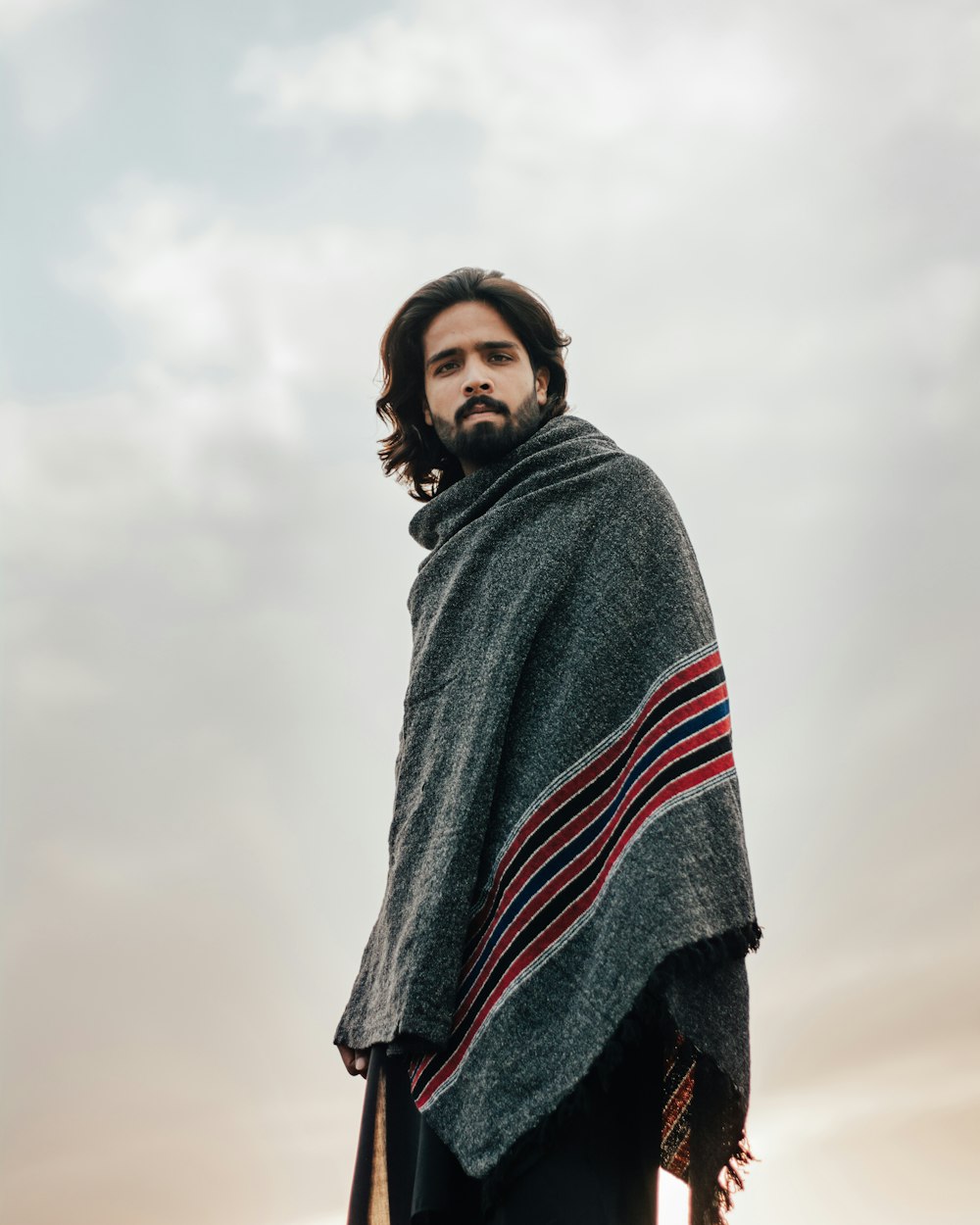 man in gray red and black striped hoodie