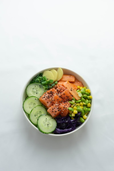 sliced cucumber and cucumber on white ceramic bowl