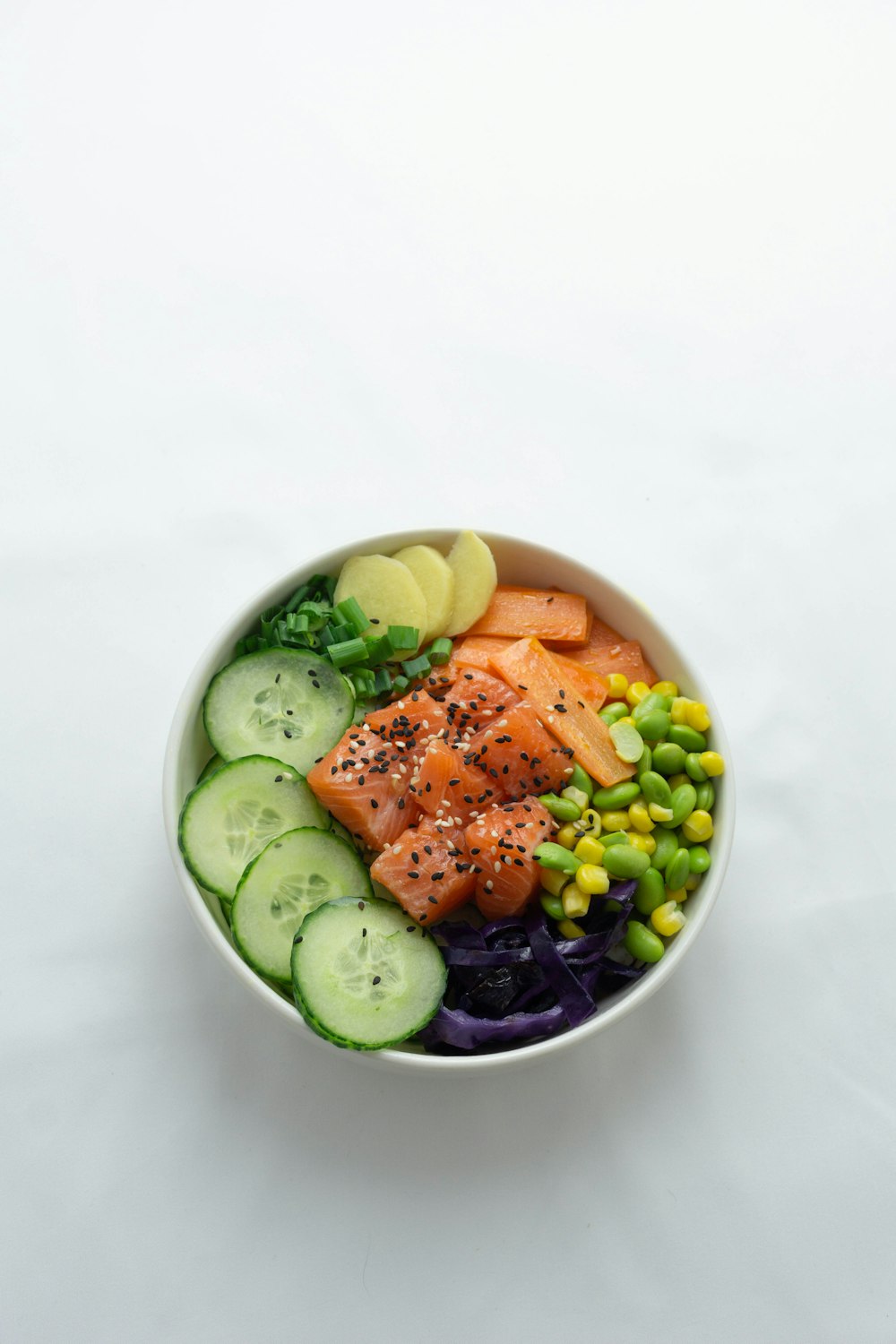 sliced cucumber and cucumber on white ceramic bowl