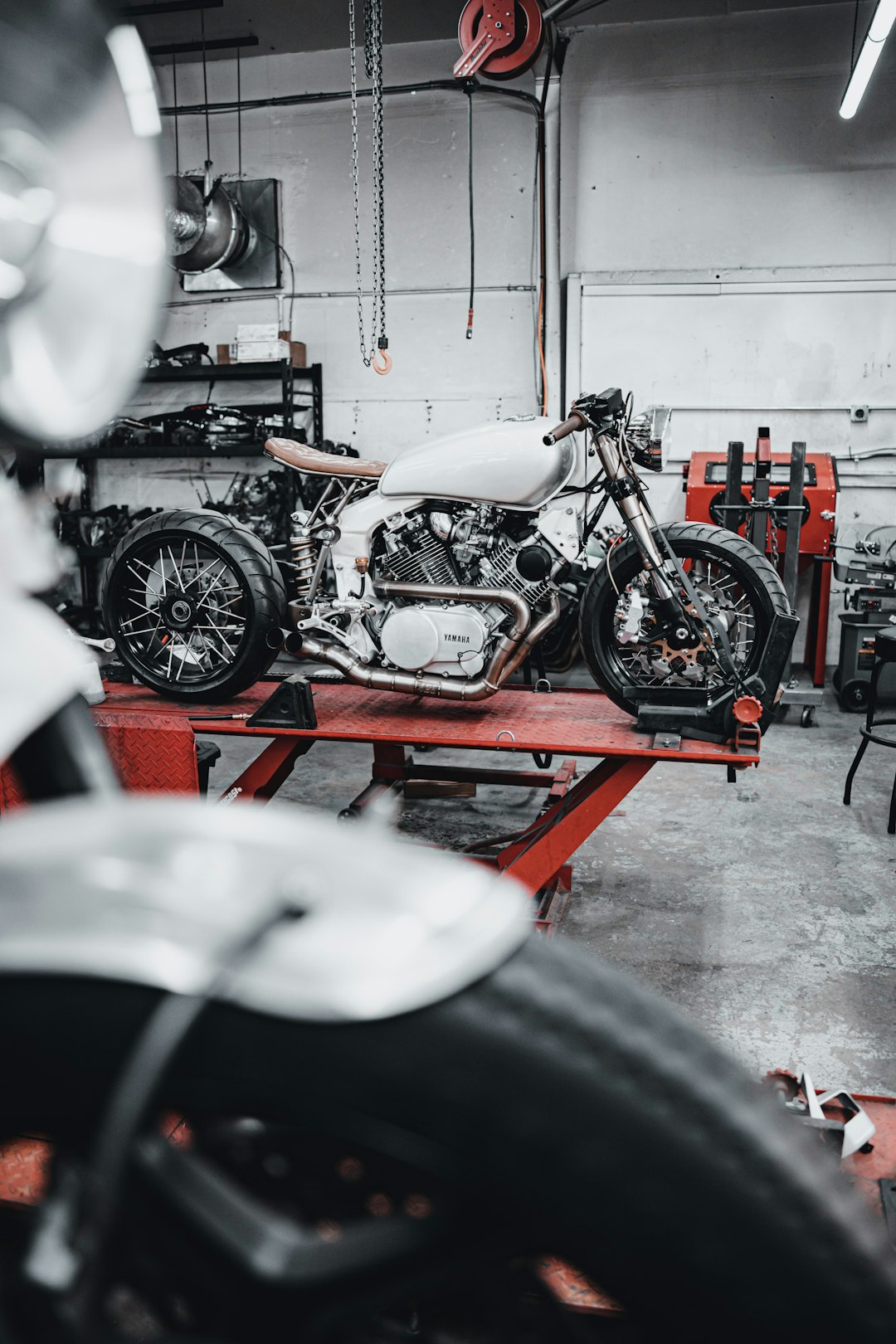 white and black motorcycle in garage