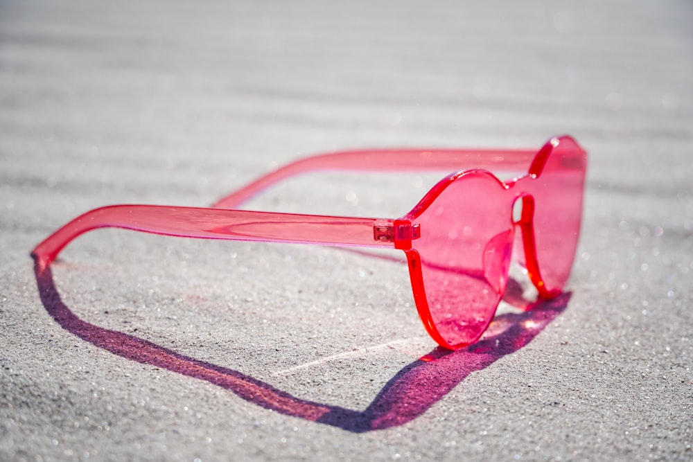 red framed eyeglasses on gray textile