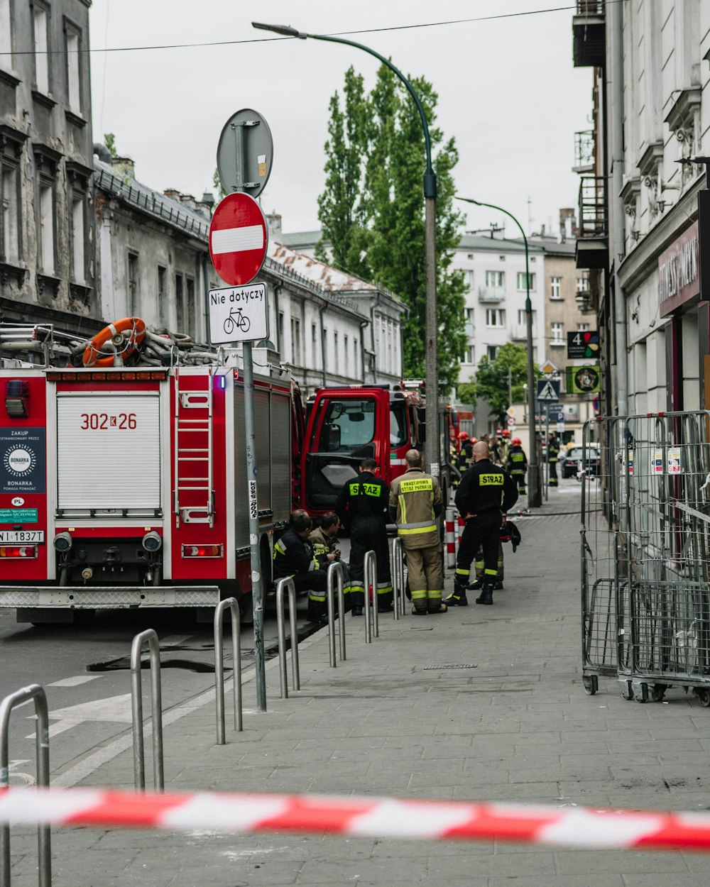 people in red and white fire truck on road during daytime