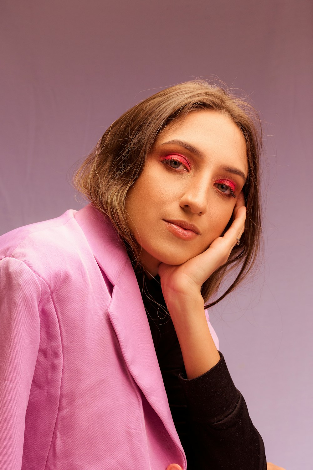 woman in pink blazer smiling