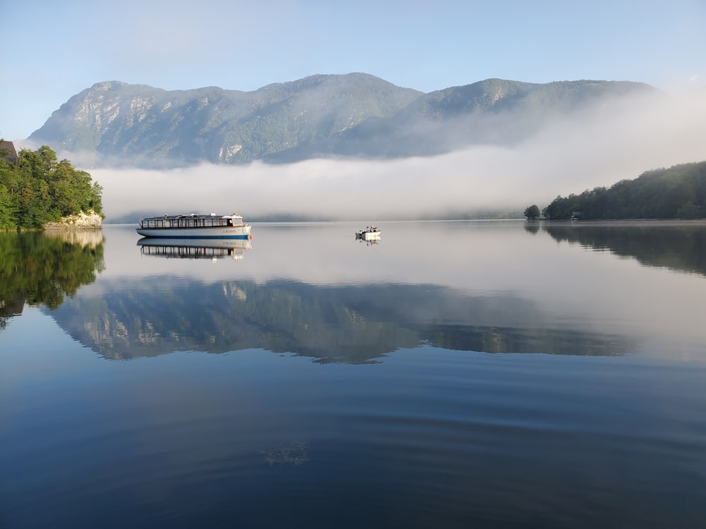 boat on water near mountain during daytime