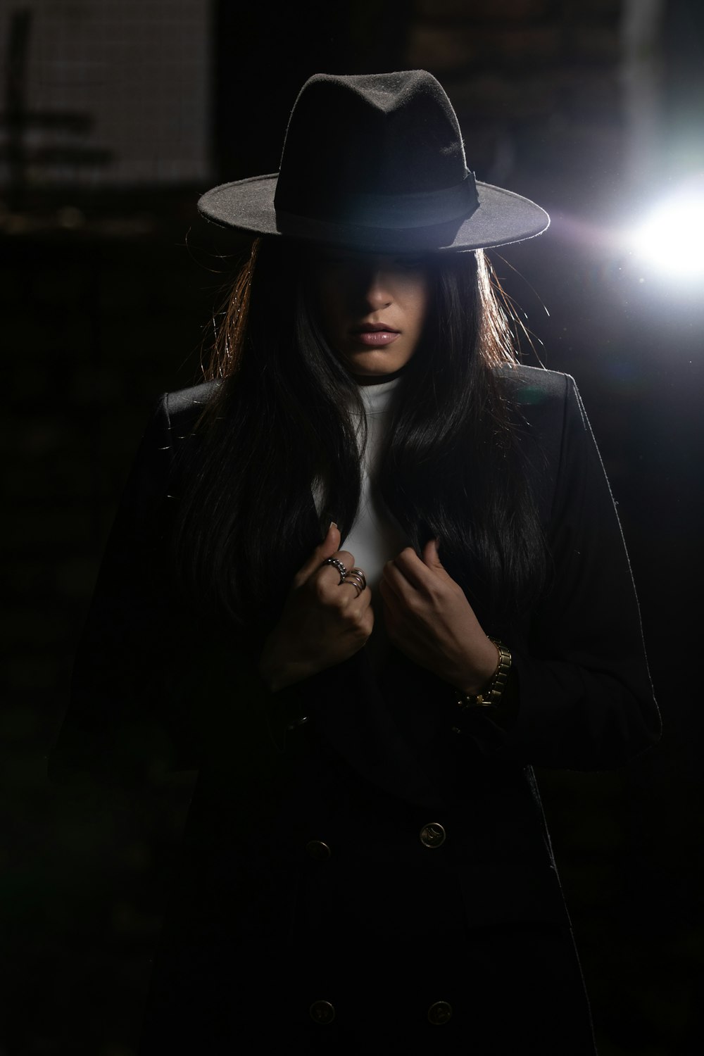 woman in black coat wearing black hat