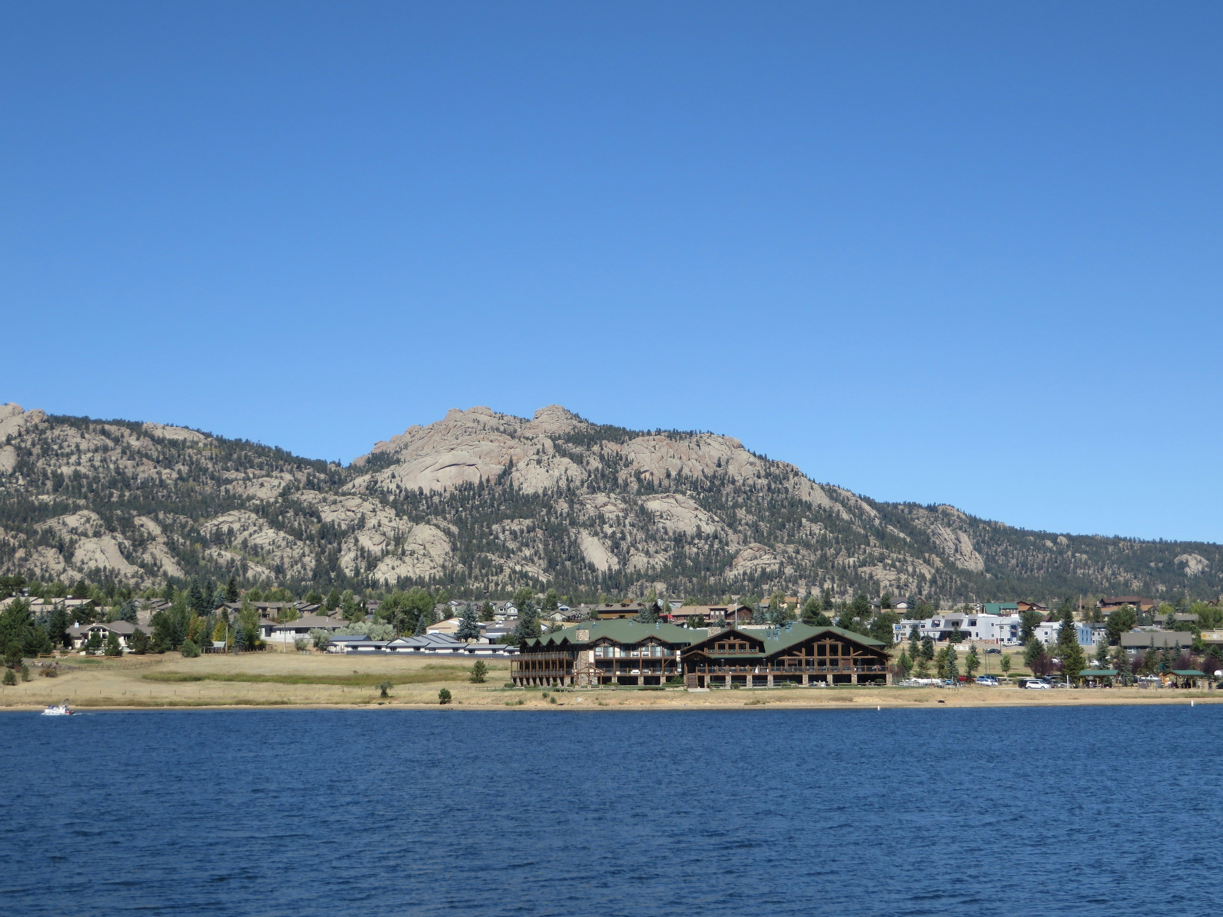 white and brown building near body of water during daytime