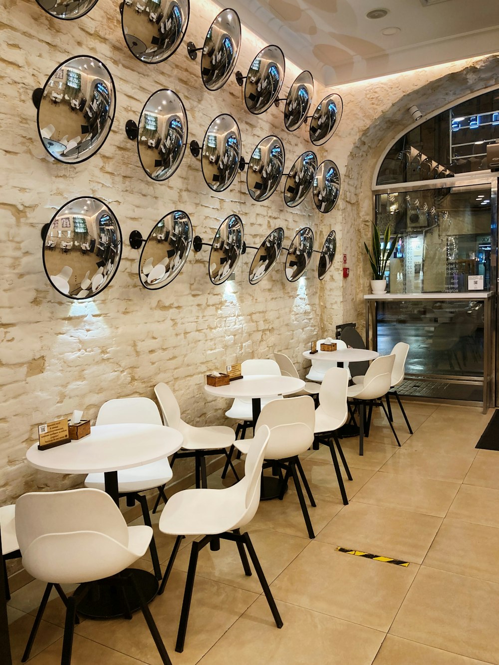 white and black chairs on brown floor tiles