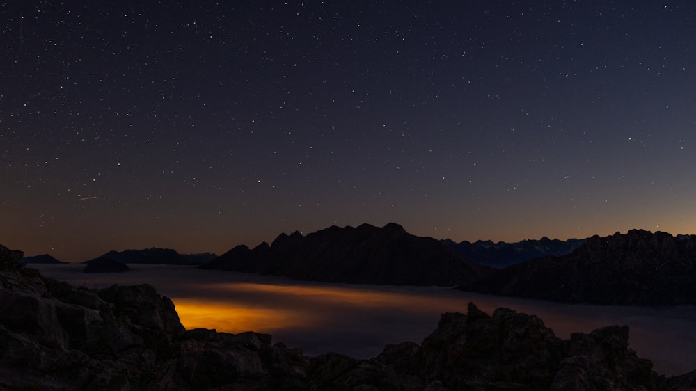 silhouette of mountain during night time