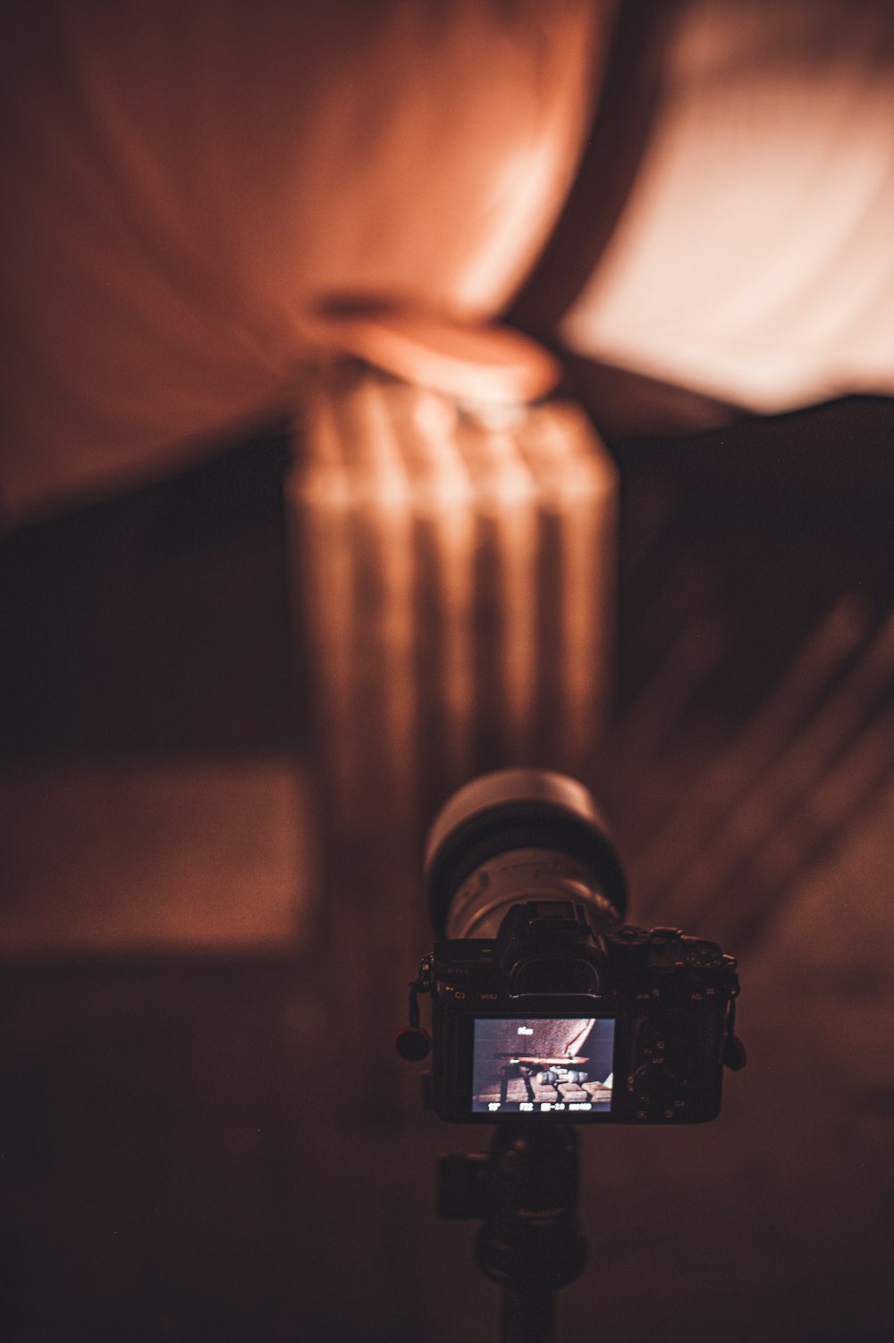 black dslr camera on brown wooden table