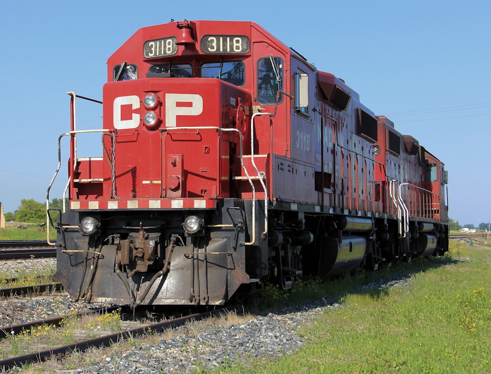 red train on rail tracks during daytime