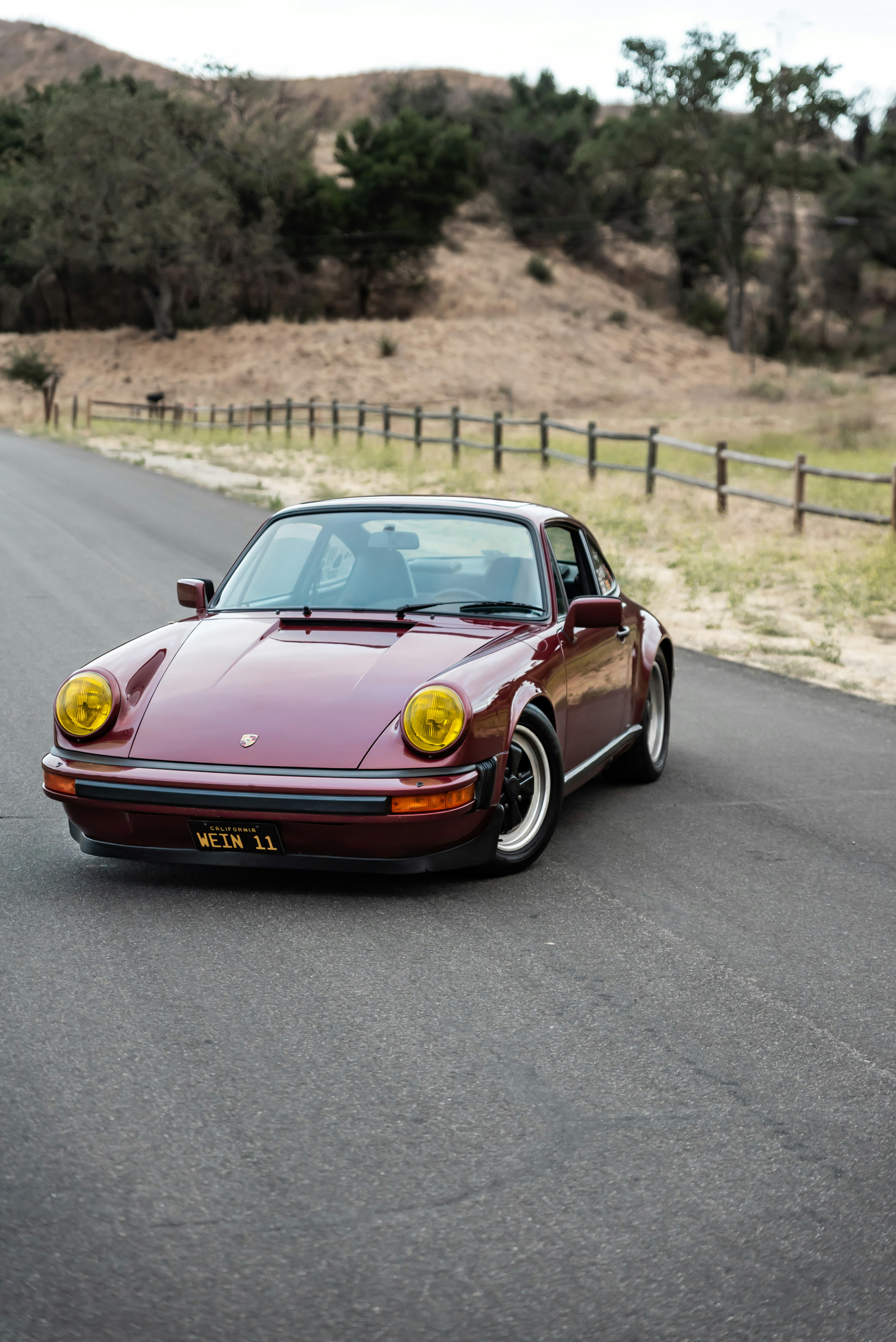 red-and-yellow-porsche-911-on-road-during-daytime