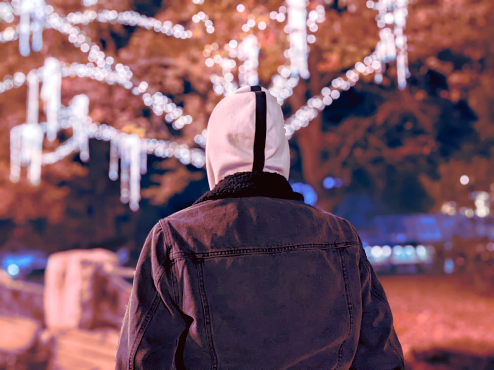 person in black jacket and white knit cap