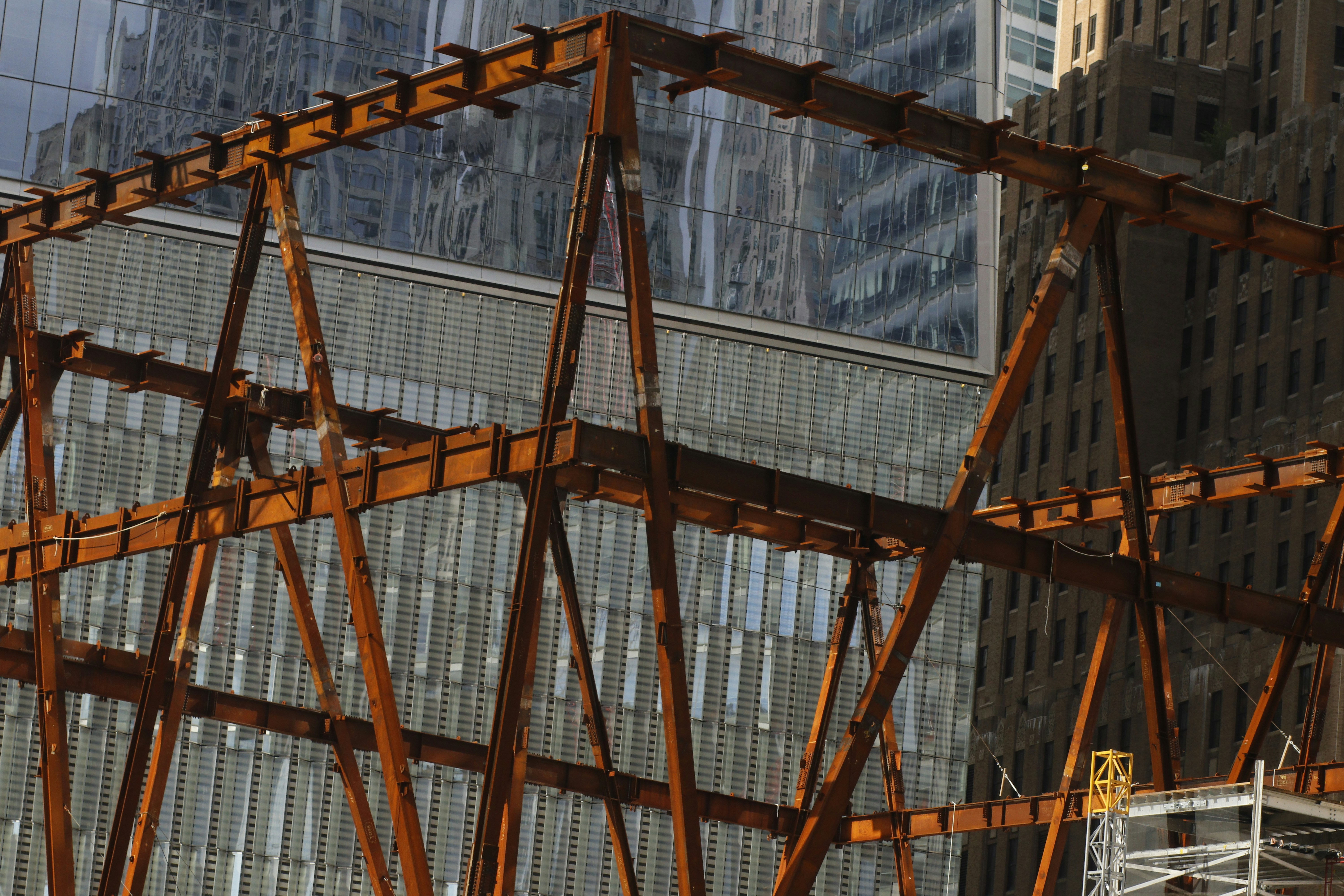 brown wooden frame near white concrete building during daytime