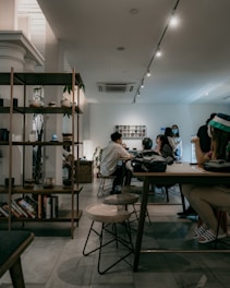 people sitting on chair in front of table