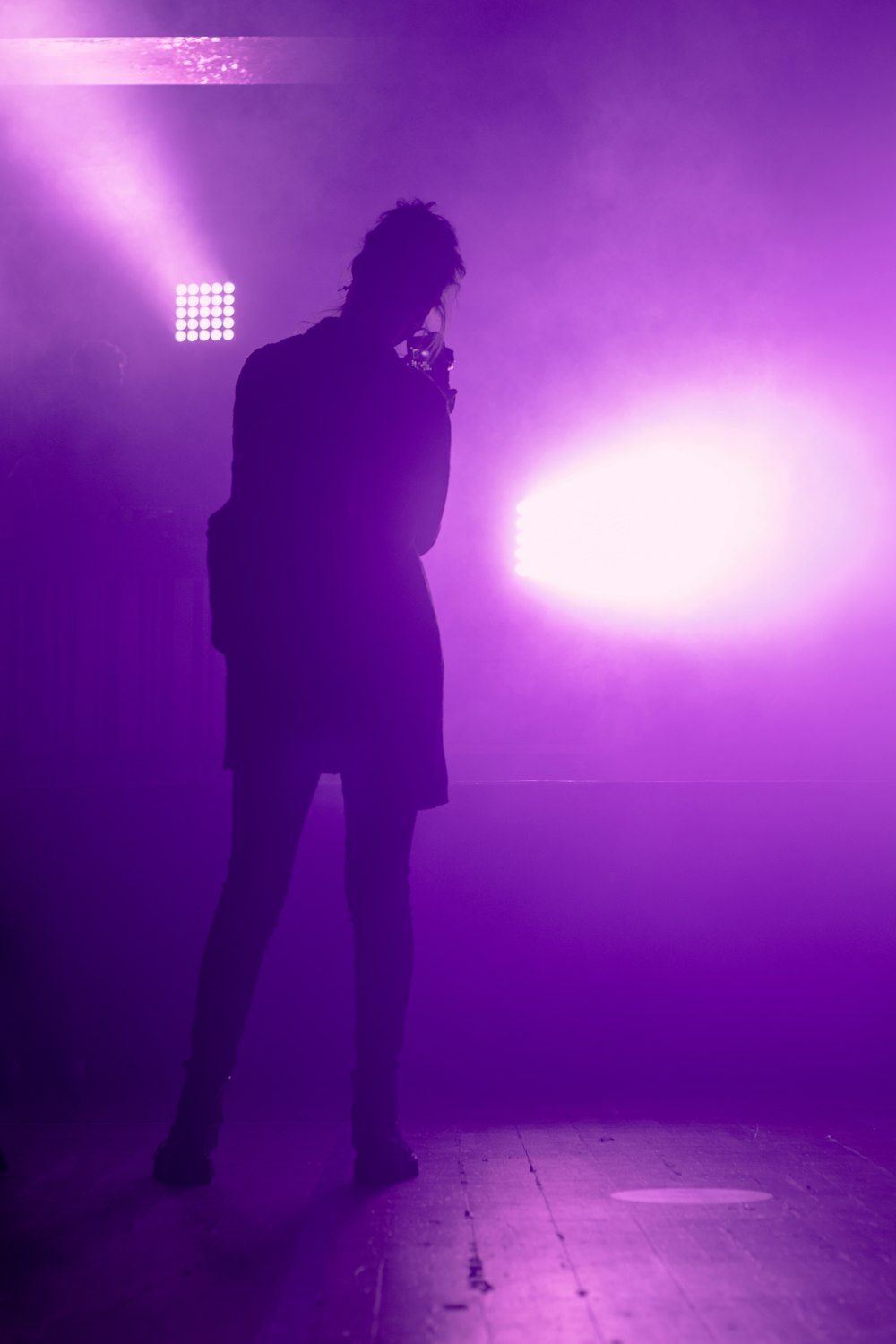 silhouette of woman standing on stage