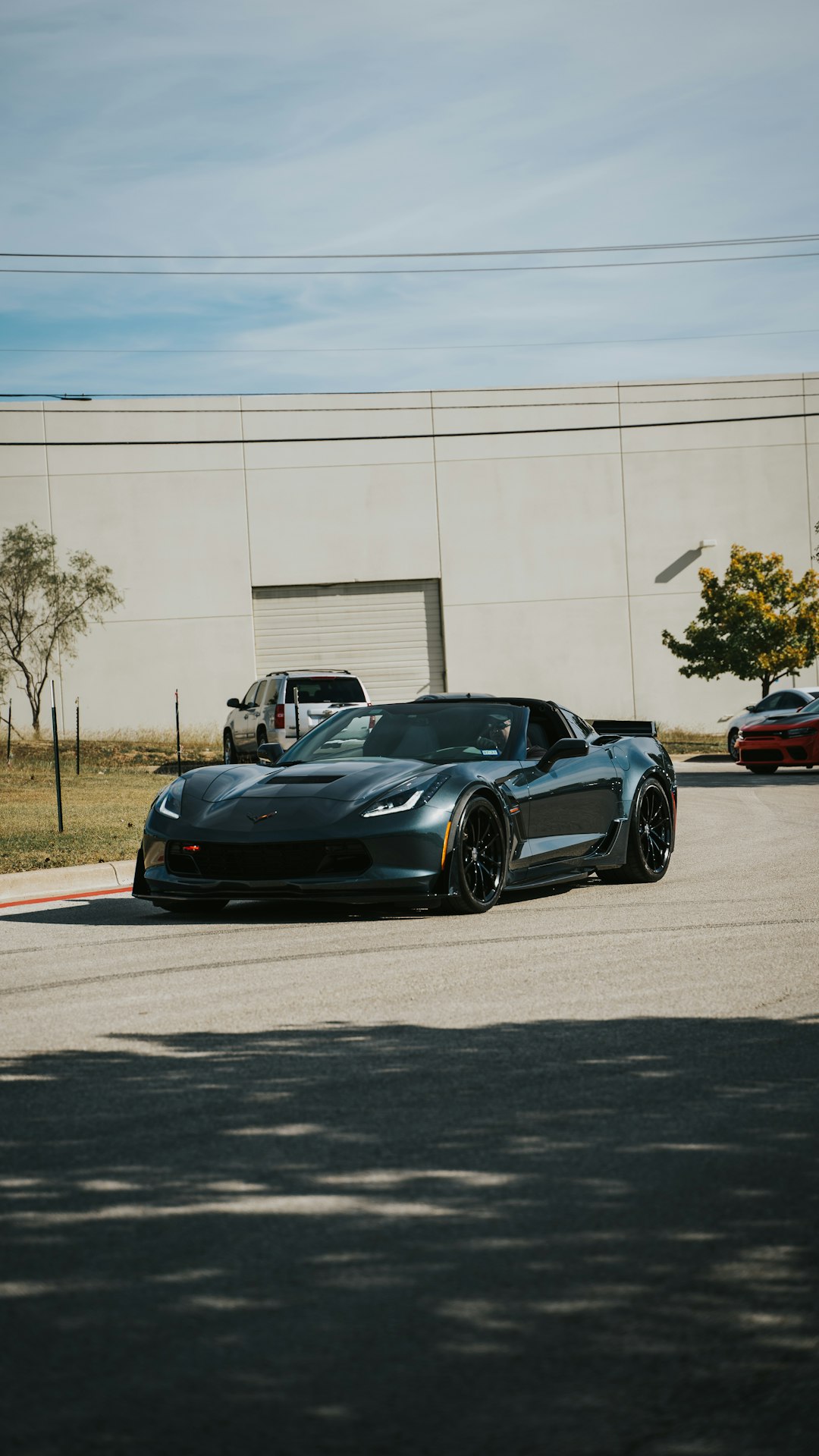 black porsche 911 parked on gray concrete road during daytime