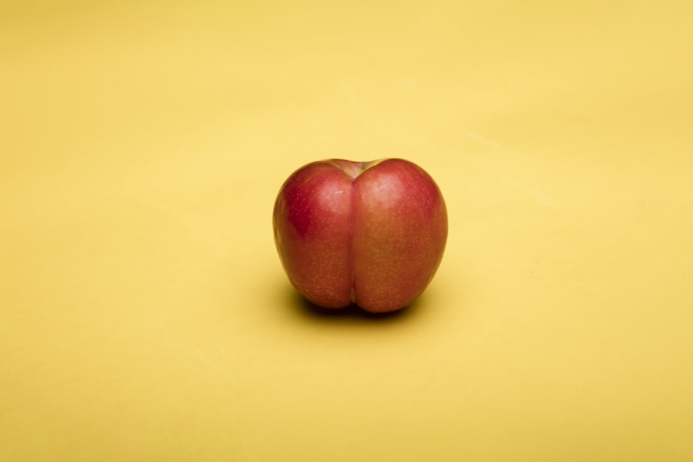 2 red apples on white table