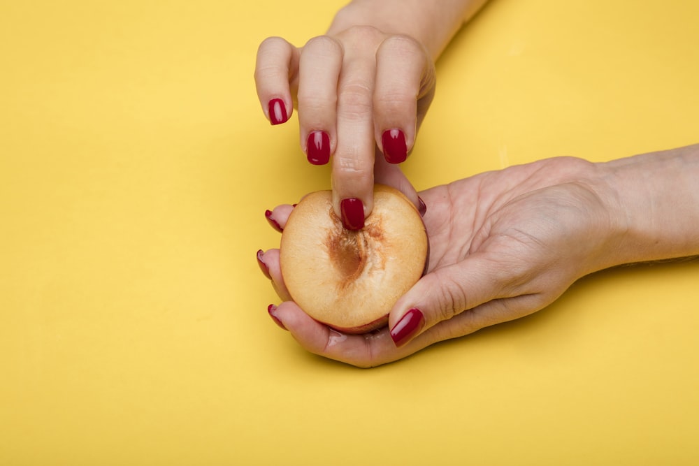 person holding sliced apple fruit