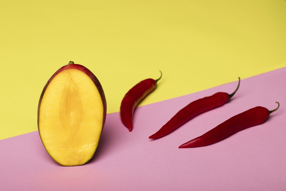 sliced yellow fruit beside red chili