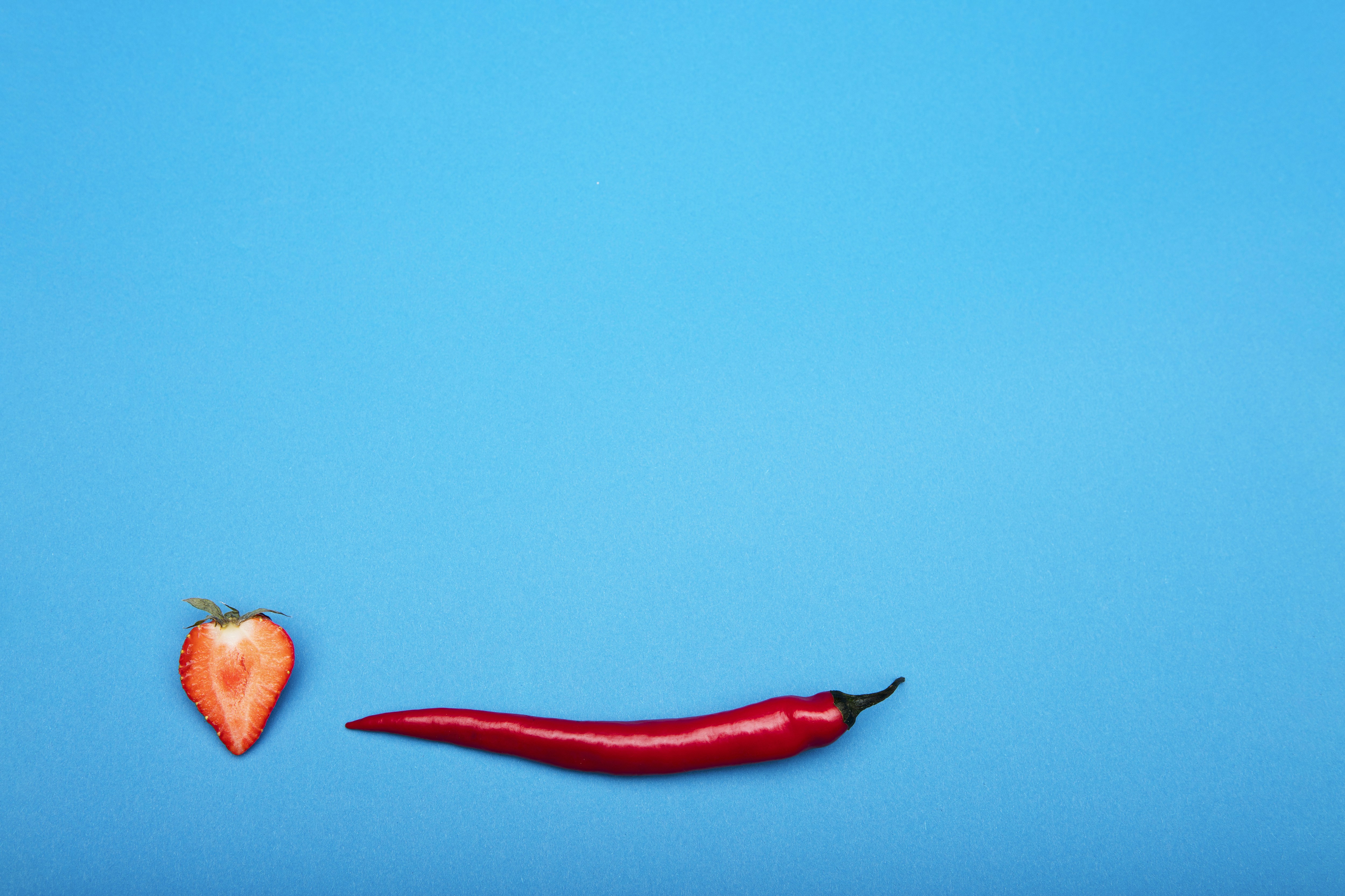red chili on pink surface