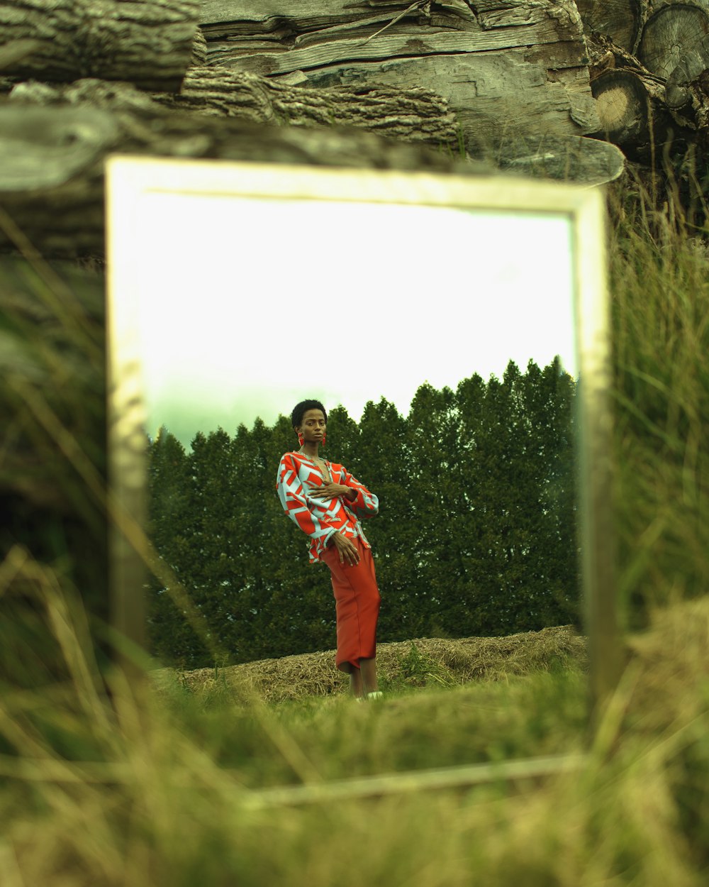 boy in red and black hoodie standing on green grass field during daytime