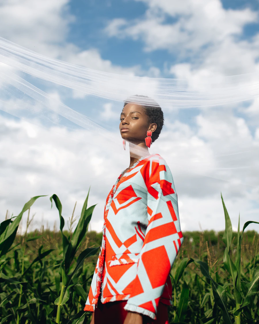 Woman in a floral shirt standing in a grass field