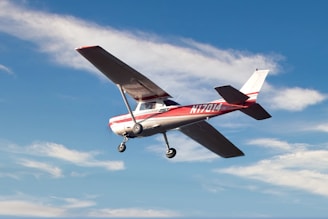 red and white airplane flying in the sky during daytime