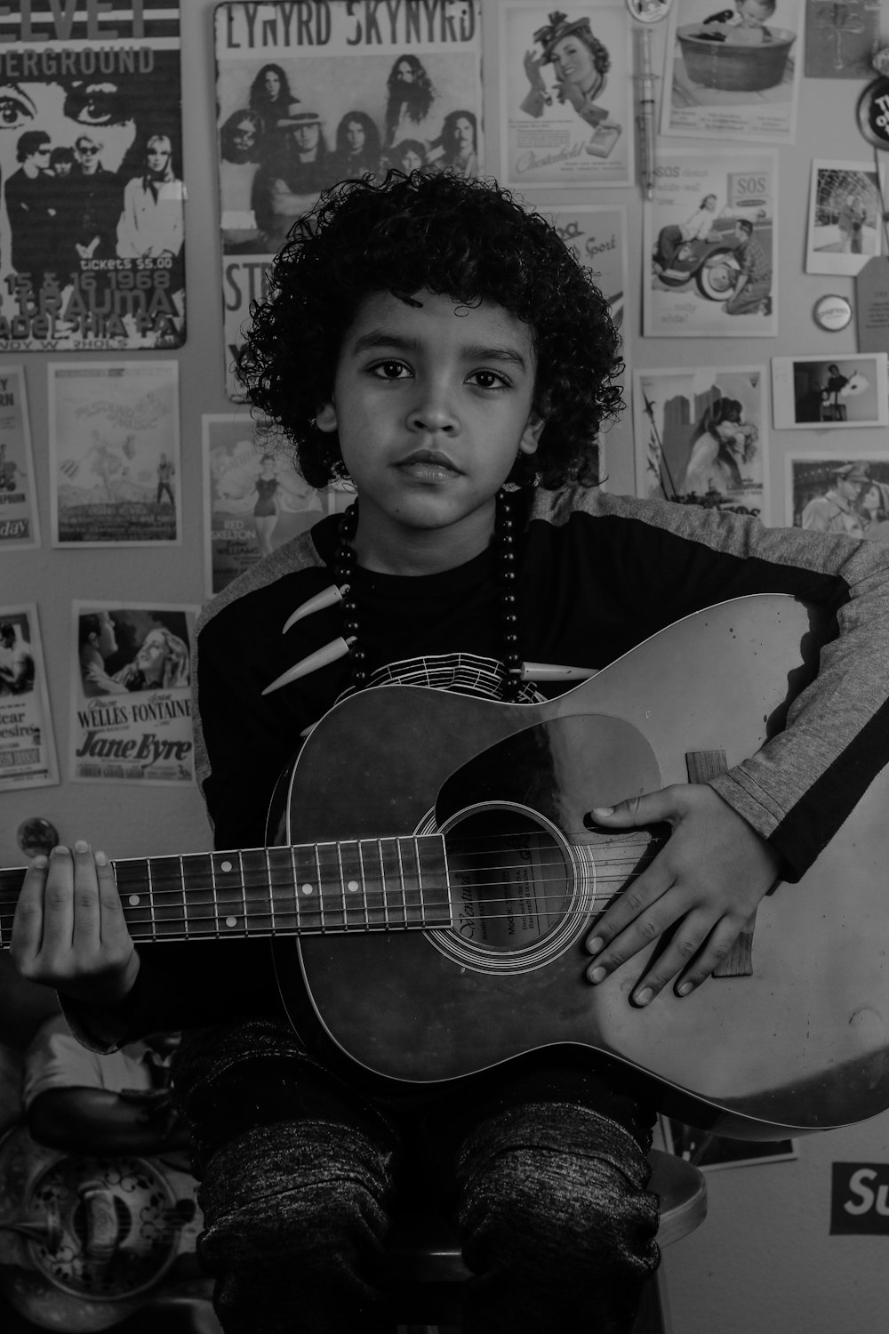 man in black crew neck t-shirt playing acoustic guitar