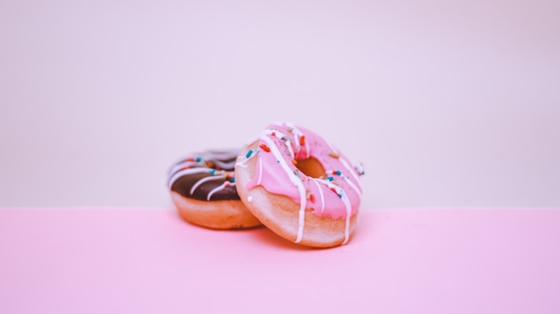 brown and white doughnut on white surface