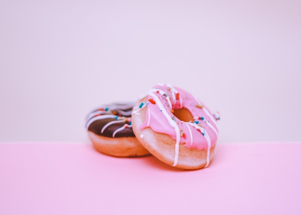 brown and white doughnut on white surface