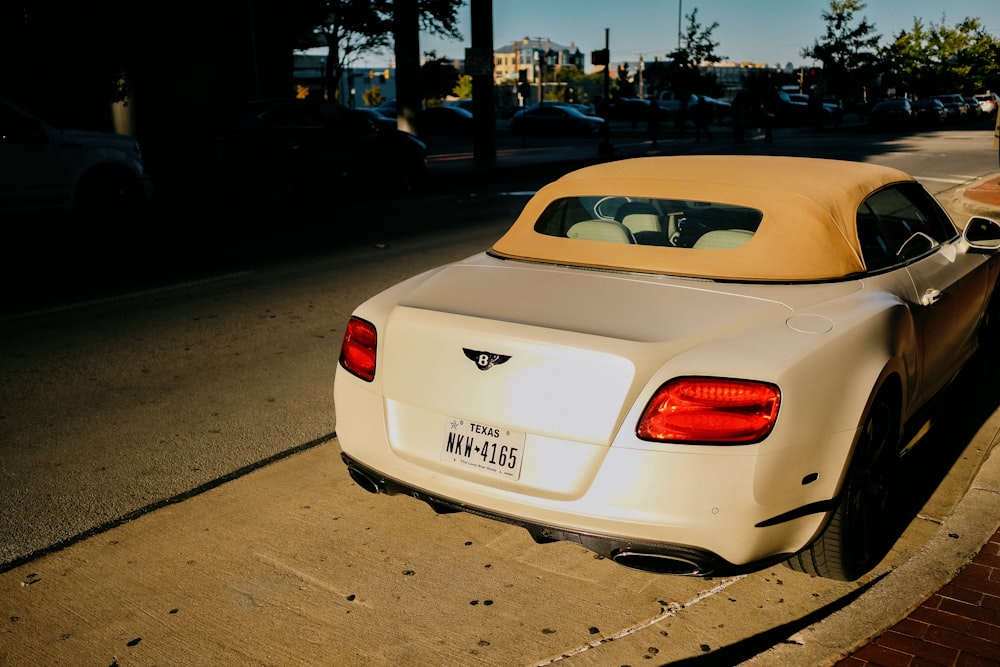 white porsche 911 parked on street during daytime