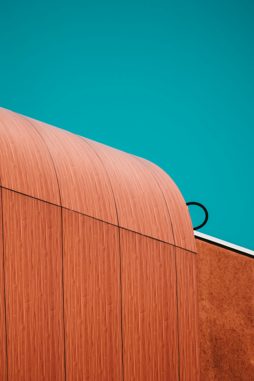 brown wooden wall under blue sky during daytime