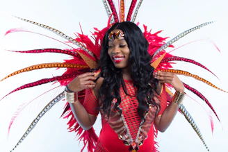 woman in red and black dress with red and white feather headdress