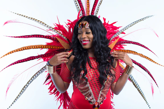 woman in red and black dress with red and white feather headdress