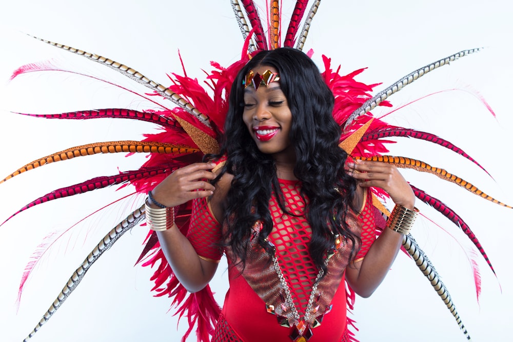 woman in red and black dress with red and white feather headdress