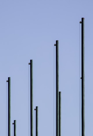 white metal pole under gray sky