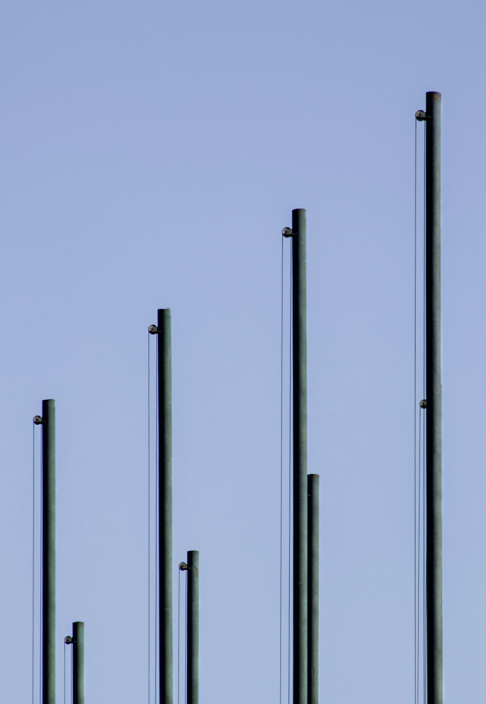 white metal pole under gray sky