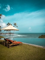 brown wooden lounge chairs on beach shore during daytime