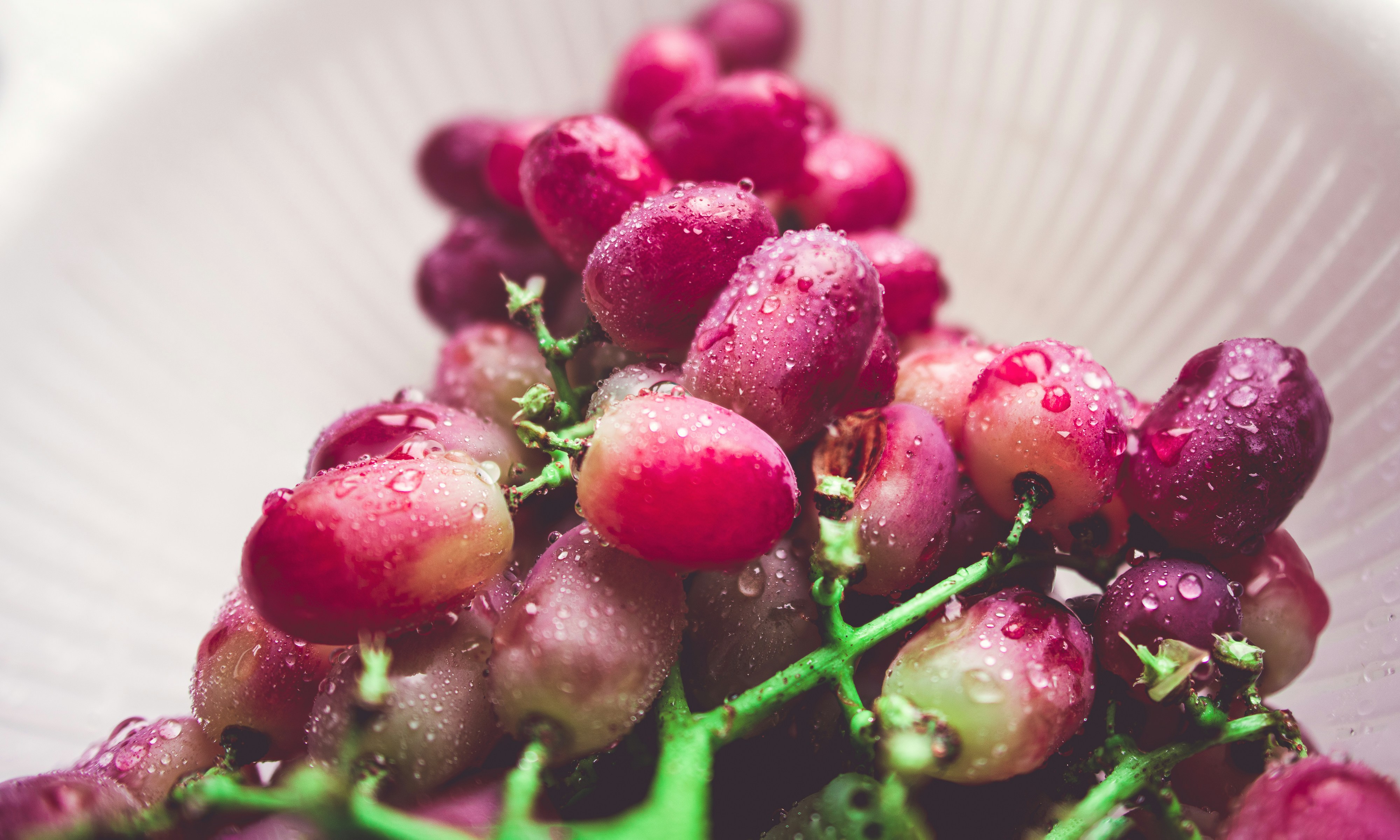 red raspberry on white plastic basket