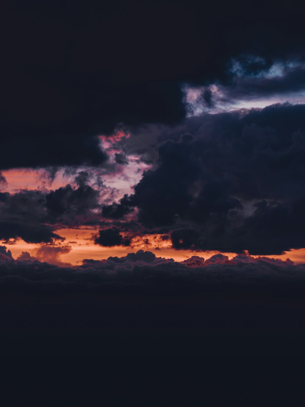 black clouds and orange sky