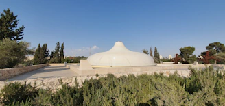 A sleek dome structure nestled in a lush landscape, showcasing modern modular design in action.