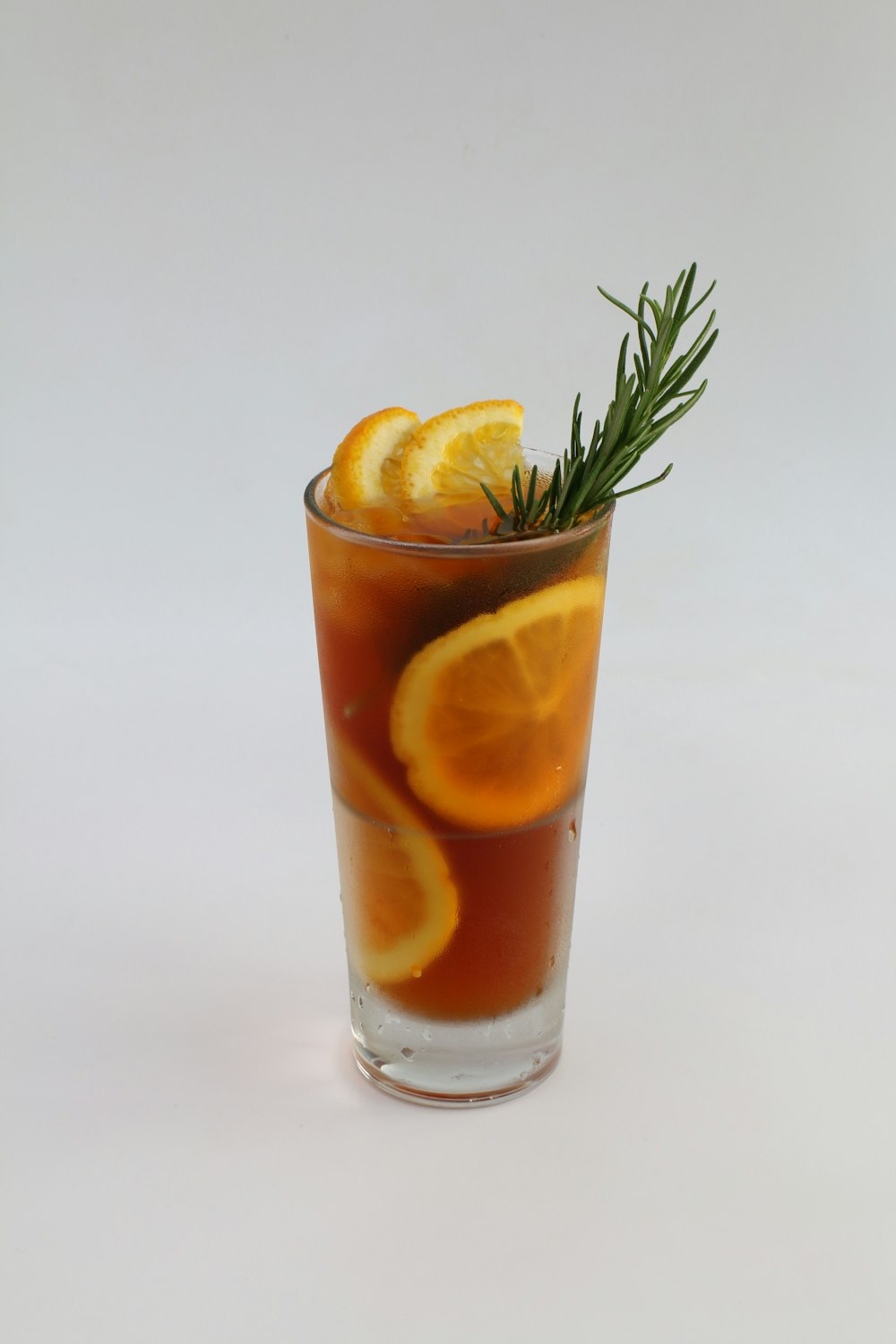 orange juice in clear drinking glass