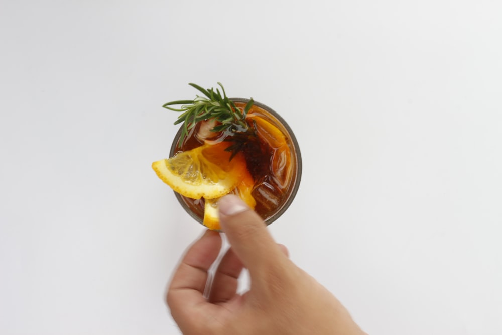 person holding yellow lemon fruit