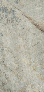 Side view of a granite facade with natural veining and texture visible in the stone.