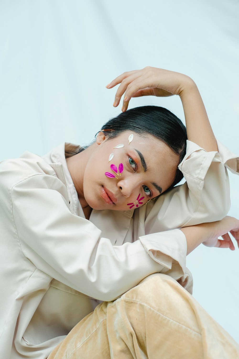 woman in white dress shirt with pink and white face paint