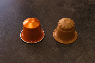 Technicians inspecting coffee capsules during quality control.