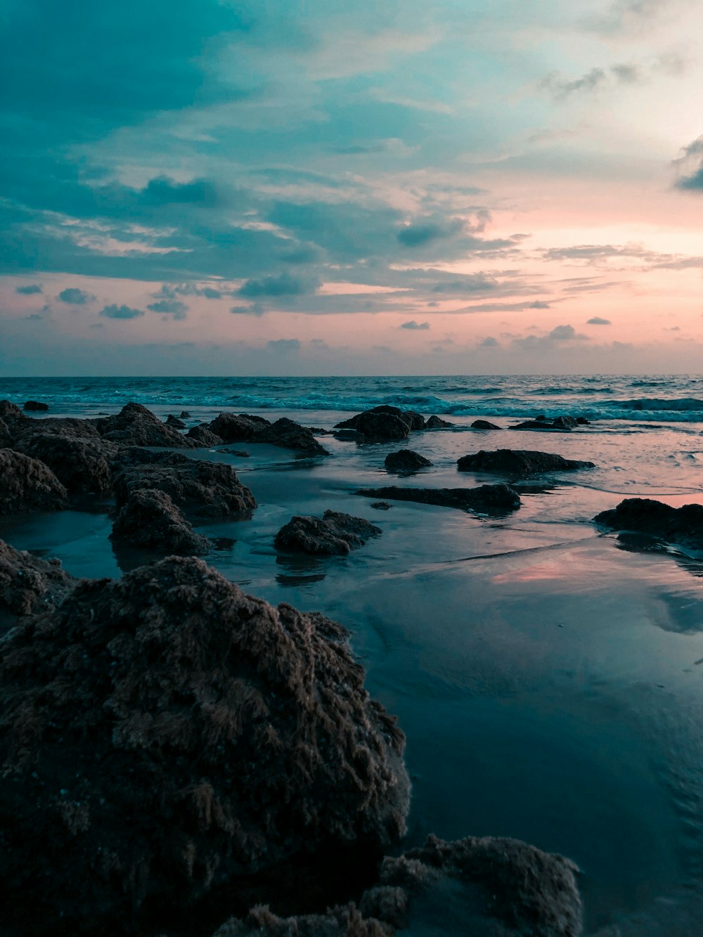 rocky shore under blue sky during daytime