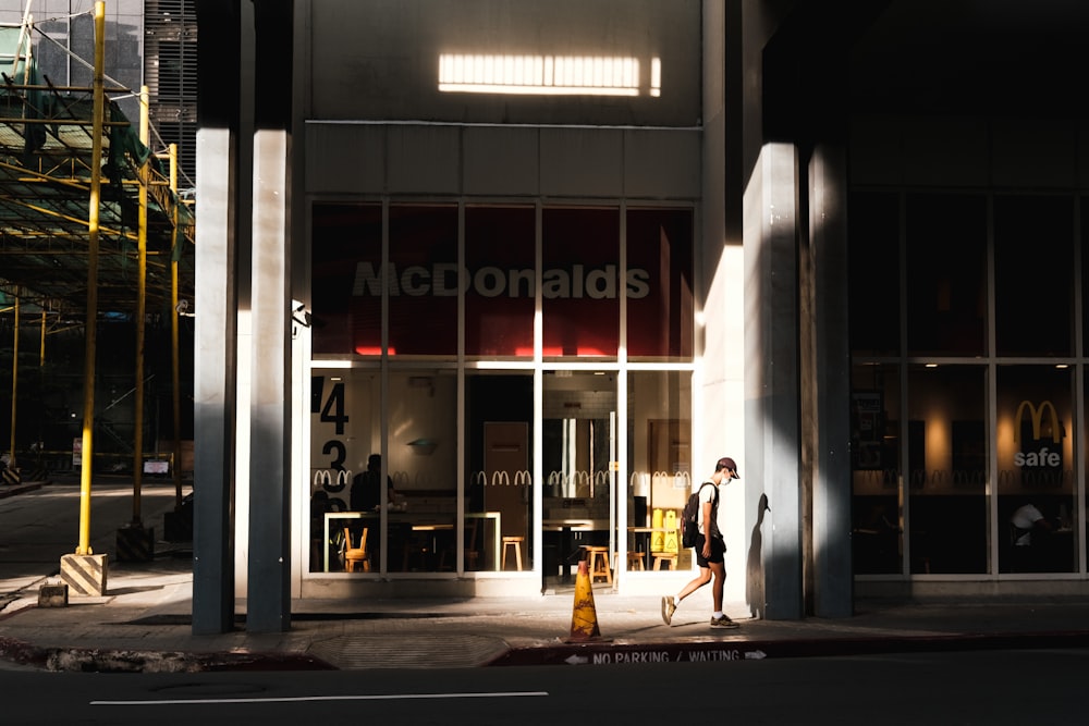 woman in white dress walking on sidewalk during daytime