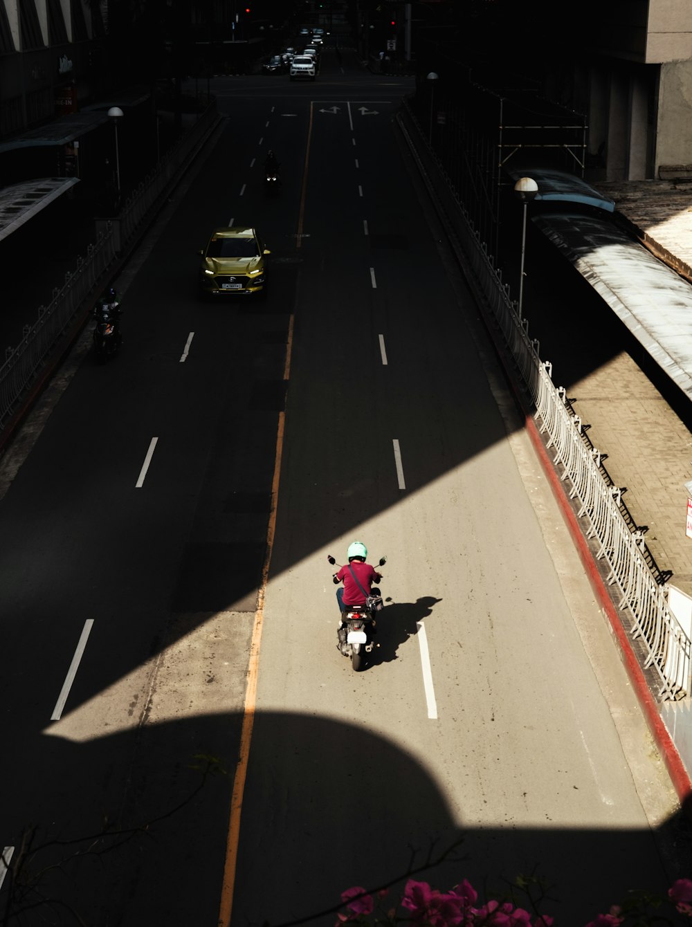 man in red jacket riding motorcycle on road during daytime